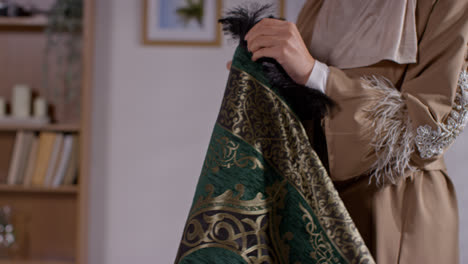 Close-Up-Of-Muslim-Woman-At-Home-Laying-Down-Prayer-Mat-On-Floor